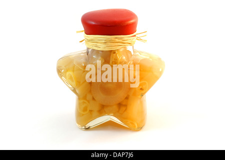 Yellow vegetables in a glass bottle for decoration over white background isolated Stock Photo