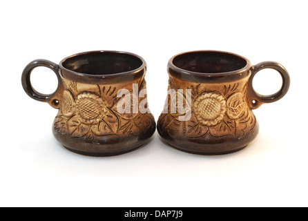 Two brown ceramic cofee cups handmade isolated over white Stock Photo