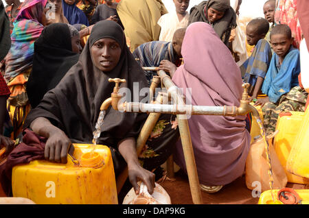 refugee camp canisters drinking fill water dadaab alamy