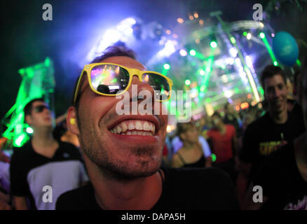 Tens of thousands of ravers dance at night in the former US cruise missile base Pydna at the 'Nature One' techno festival near Kastellaun, Germany, 06 August 2011. The festival is expecting around 55,000 visitor and is the largest festival for electronic music in Germany. Photo: Thomas Frey Stock Photo