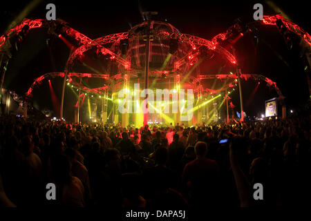 Tens of thousands of ravers dance at night in the former US cruise missile base Pydna at the 'Nature One' techno festival near Kastellaun, Germany, 06 August 2011. The festival is expecting around 55,000 visitor and is the largest festival for electronic music in Germany. Photo: Thomas Frey Stock Photo