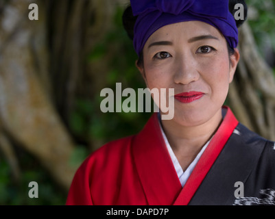 Okinawan woman in traditional kimono at Ryukyu Mura, historical village, Okinawa, Japan Stock Photo