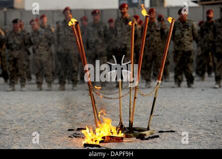 An emblem of the German Bundeswehr that is surrounded by burning ...