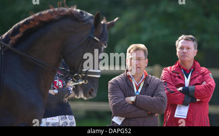 (l-r) Klaus Martin Rath, the German dressage rider coach Holger Schmezer and watch German dressage rider Matthias Alexander Rath ride his horse Totilas (not pictured) during the training at the European Dressage Championships in Rotterdam, Netherlands, 19 August 2011. Individual competitions will take place on 20 August. Photo: UWE ANSPACH Stock Photo