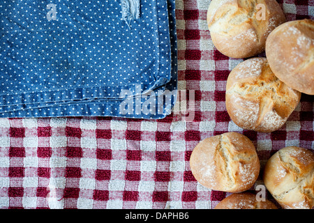 Crusty, rustic rolls, home baked, straight from the oven. Blue and red cloth, top down view, shallow depth of field. Stock Photo