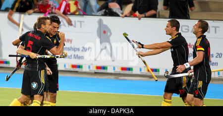 Belgian Jerome Dekeyser (L) celebrates after his winning goal during the men's EuroHockey Nations Championship group A match between the Belgium and Spain at Hockey Park in Moenchengladbach, Germany, 24 August 2011. Belgium won by 3-2 and qualifies for the EuroHockey Nations Championships semi-final and the Olympic Games 2012.  Photo: ROLAND WEIHRAUCH Stock Photo