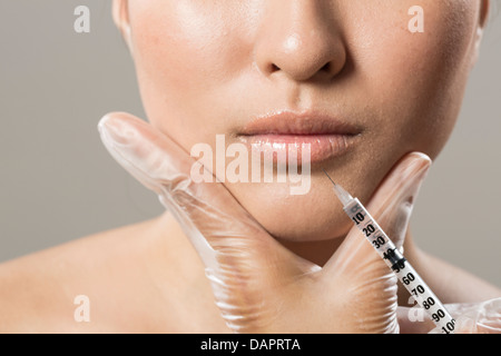 Chinese woman receiving a botox injection. Beauty Treatment. Stock Photo