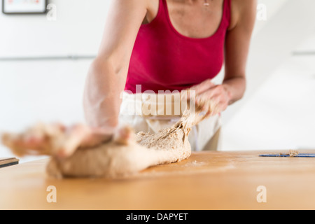 Woman Stretching Bread Stock Photo