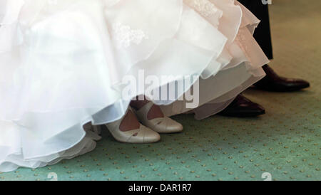 The bride and groom sit next to each other at the registrar's office in Magdeburg, Germany, 05 September 2011. Photo: Jens Wolf Stock Photo