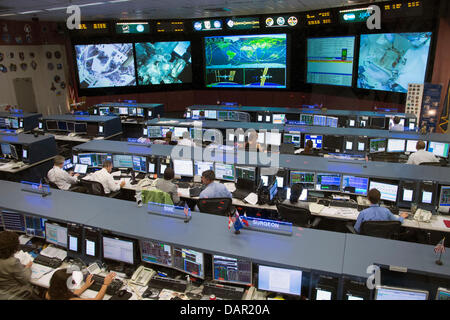An overall view of the space station flight control room of the Johnson Space Center's Mission Control Center shows flight controllers at work during the spacewalk of Expedition 36 astronauts Chris Cassidy of NASA and Luca Parmitano of the European Space Agency July 16, 2013 in Houston, TX. Issues with Parmitano's spacesuit brought the spacewalk to an early end. Stock Photo