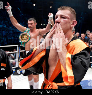 Vitali Klitschko (L) of Ukraine celebrates after the ringreferee lift his arm during the WBC Heavyweight World Championship fight vs. Tomasz Adamek (FRONT) of Poland at Wroclaw Stadium, 10 September 2011. Photo: Robert Schlesinger dpa Stock Photo