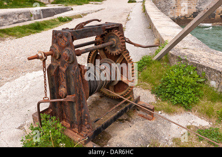 OLD WINCH ON HARBOURSIDE Stock Photo