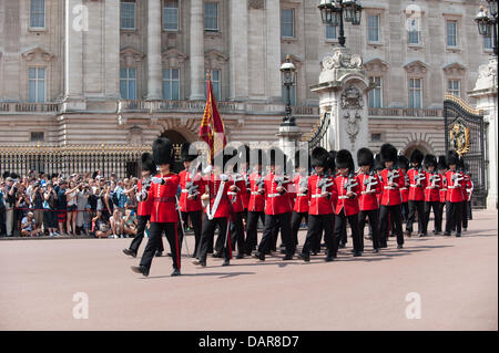London, UK. 17th July, 2013. Westminster, London, UK. Guardsmen march from Buckingham Palace to Wellington Barracks for the Changing of the Guard in 32 degrees of heat watched by thousands of tourists lining the route. A level 3 heatwave warning has been issued for the region today Credit:  Malcolm Park/Alamy Live News Stock Photo