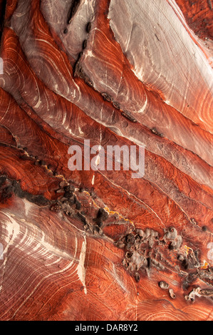 Diagonal swirls of red sandstone texture at Petra, Jordan Stock Photo