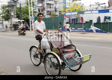 A man riding a tricycle taxi, Nha Trang, Vietnam, South East Asia. Stock Photo