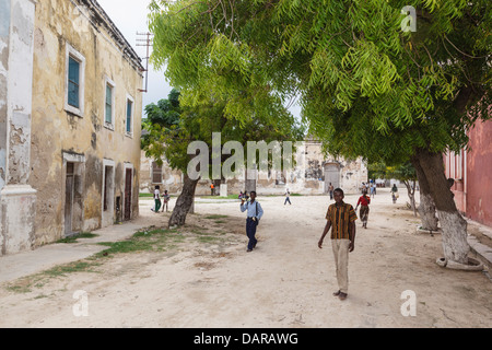 Africa, Mozambique, Mozambique Island. Teenage boys walking down street. Stock Photo