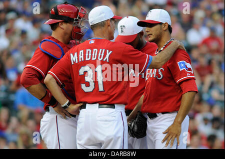 July 4, 2013 - Arlington, TX, USA - Texas Rangers pitching coach Mike Maddux visits the mound to talk with starting pitcher Martin Perez (33) after Perez walked a batter to load the bases in the second inning of an MLB baseball game between the Seattle Mariners and the Texas Rangers at Rangers Ballpark in Arlington in Arlington, TX, Thursday, July 4, 2013. Stock Photo