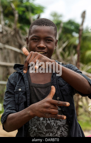 Africa, Mozambique, Quirimba Island. Teenage boy making signs for the camera. Stock Photo