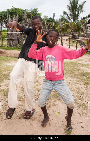 Africa, Mozambique, Quirimba Island. Teenage boys making signs for the camera. Stock Photo