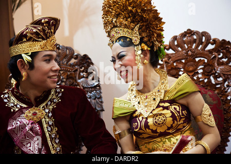 Wedding couple are grinning at each other at their wedding in Ubud, Bali Stock Photo