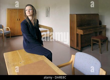 Harp player Assia Cunego from Italy sits in a future classroom of her harp school behind the Weser dike near Sandstedt, Germany, 28 June 2013. The musician creates a harp boarding school in the former hotel (BACK). Future students are offered a peacable location to study the instrument. Photo: INGO WAGNER Stock Photo