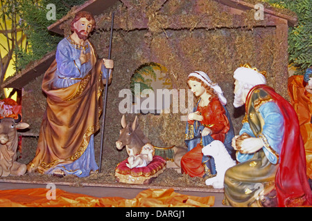 christmas nativity scene of jesus birth in an old cottage nearby bethlehem with joseph, mary and three shepherd Stock Photo