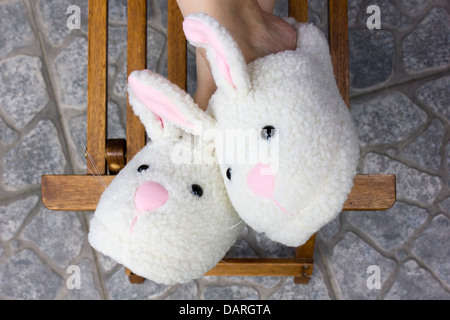 feet with bunny slippers Stock Photo