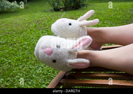 feet with bunny slippers Stock Photo
