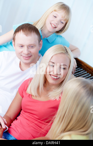 Portrait of parents and children talking at home during rest Stock Photo