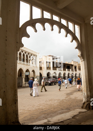 Africa, Eritrea, Massawa, Old Town, group of cruise ship passengers passing Ottoman architecture building Stock Photo