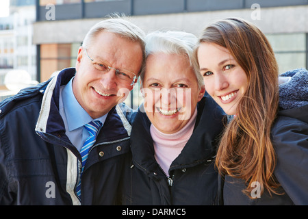 Happy senior grandparents smiling with their grandchild Stock Photo