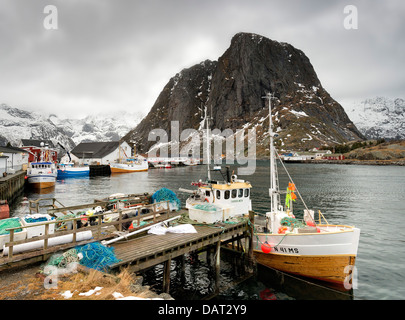 Fishing boats in the harbour at Hamnoy on the Lofoten Islands, Norway, with mount Lilandstinden in the background Stock Photo