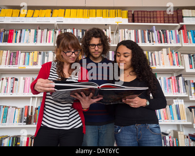Multi ethnic group of people reading book in a library Stock Photo
