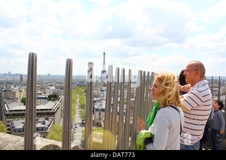 Tourists overlooking Paris from the top of the Arc de Triomphe in Paris, France Stock Photo