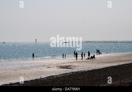 Littlehampton UK 18 July 2013 - People enjoying the sunshine in the late afternoon on Littlehampton beach along the south coast as the heatwave continues in Britain today Photograph taken by Simon Dack/Alamy Live News Stock Photo