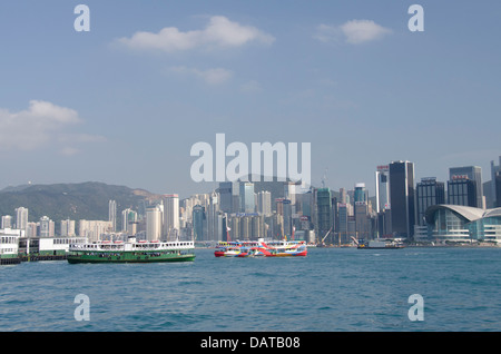 Asia, Hong Kong. Hong Kong Island city skyline view from Victoria Harbor. Kowloon ferry boat. Stock Photo