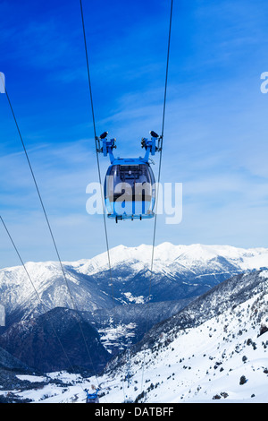 Front view of ski lift cable car with valley and mountains on the background Stock Photo