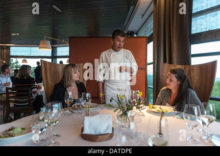 3 star Michelin Chef Regis Marcon talking to guests at his restaurant, Régis & Jacques Marcon. St-Bonnet-le-Froid. France Stock Photo