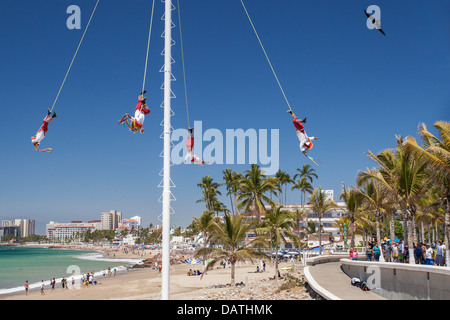 Voladores fly as tourists look on in Puerto Vallarta, Mexico. Stock Photo