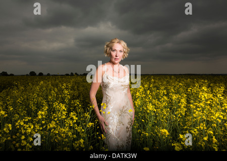 woman standing in field in open countryside Stock Photo
