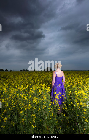 woman standing in field in open countryside Stock Photo