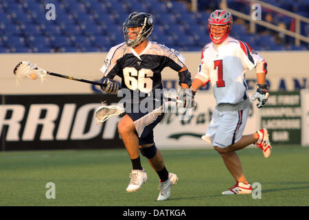 July 18, 2013 - Annapolis, Maryland, United States - July 18, 2013: Chesapeake Bayhawks #66 Mike Simon runs past Boston Cannon's #7 Matt Poskay at Navy-Marine Corps Memorial Stadium, in Annapolis, Maryland. Daniel Kucin Jr./ CSM Stock Photo