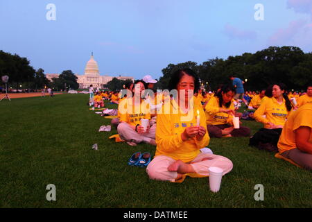 Washington DC, USA. 18th July, 2013. Falun Gong members commemorate the 14th anniversary of the Chinese government crackdown against them which began on 20th July 1999. In the background is the United States Capitol Building. Credit:  James Brunker / Alamy Live News Stock Photo