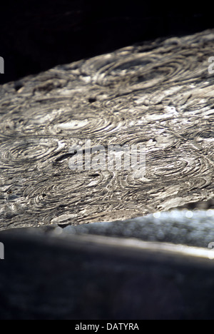 Fossils of ammonites in rock at Kimmeridge Bay, Dorset, England UK Stock Photo