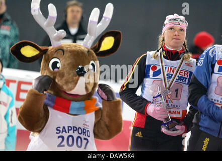 Evi Sachenbacher-Stehle (R) of Germany pictured with her silver medal and masocit Norkey (L) after the Women's Team Sprint event of the Nordic World Ski Championships in Sapporo, Japan, Friday, 23 February 2007. Photo: Gero Breloer Stock Photo