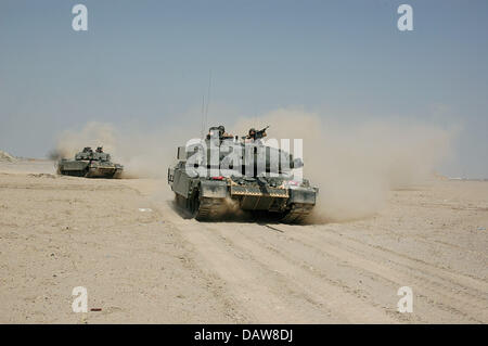 British soldiers patrol on two Challenger 2 tanks in the desert near Basra, Iraq, June 2006. Photo: Carl Schulze Stock Photo