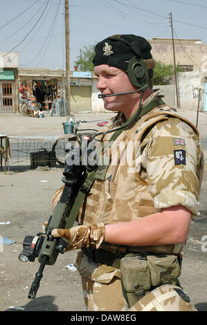 A British soldier of the Multinational Division South East is pictured with his SA80A2 assault rifle during a patrol in Basra, Iraq, June 2006. Photo: Carl Schulze Stock Photo