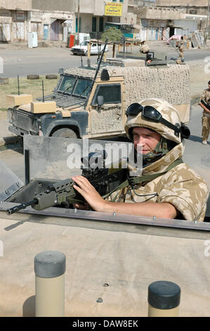 A British soldier of the Multinational Division South East is pictured with his SA80A2 assault rifle on a  Land Rover 110 Composite Armor Vehicle 'Snatch' during a patrol in Basra, Iraq, June 2006. Photo: Carl Schulze Stock Photo
