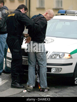 A police officer handcuffs a rioter before the EURO 2008 qualifier Czech Republic v Germany in Prague, Czech Republic, 24 March 2007. Photo: Bernd Weissbrod Stock Photo