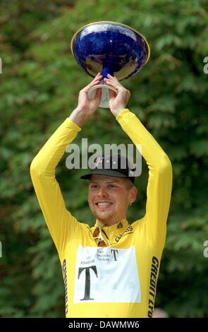 (dpa file) The file picture ddated 27 July 1997 shows German former cycling pro Jan Ullrich of Team Telekom lifting the 1997 Tour de France winner's trophy in Paris, France. Jan Ullrich will finally comment on his past in sports, as Ullrich's manager Wolfgang Strohband announced in the German daily 'Die Welt', leaving the when and the how open. Within the last week, Ullrich's forme Stock Photo